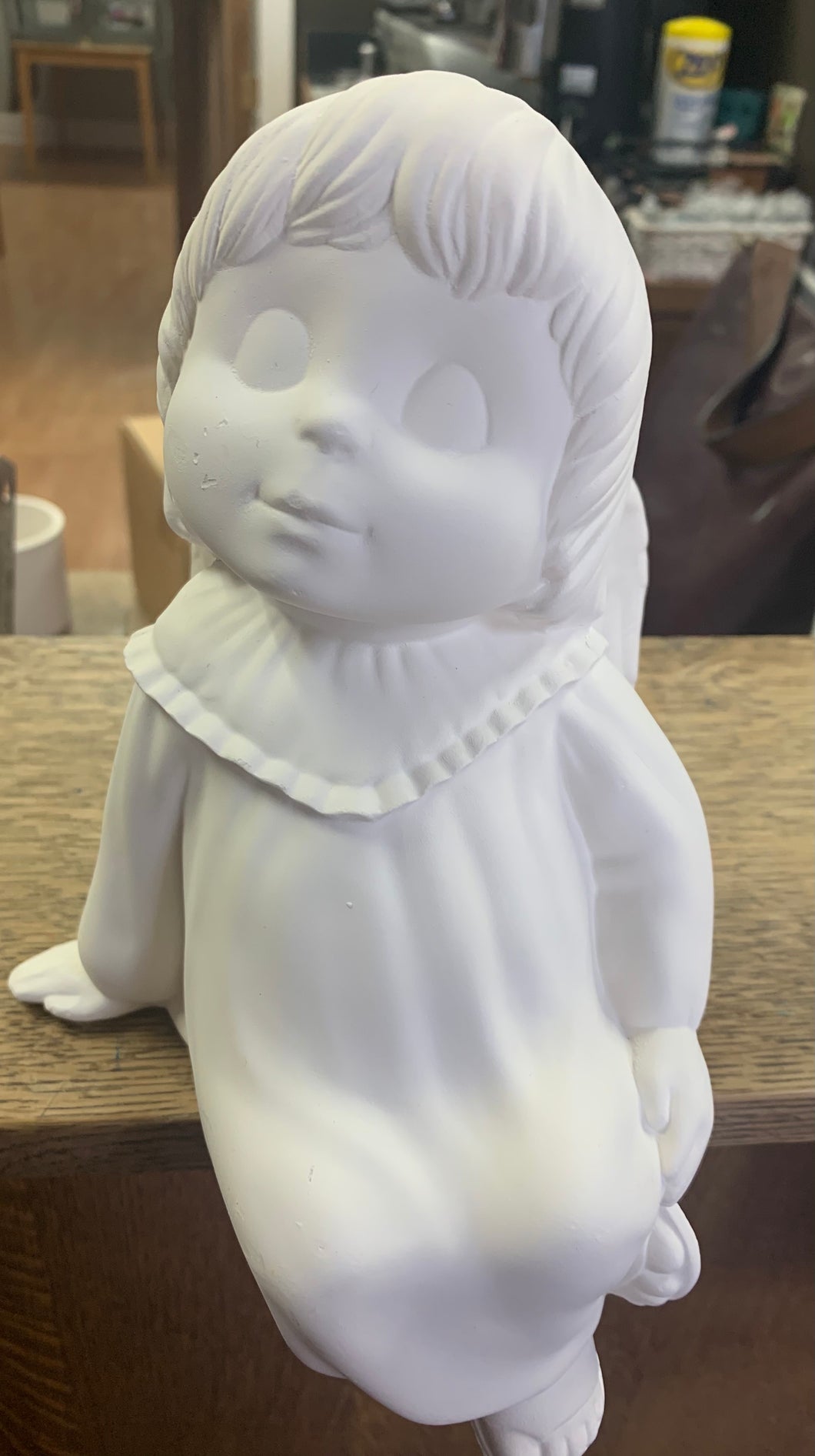 Boy side sitting angel shelf sitting